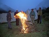 9 6 Campfire At Joksam Camp Although normally trekking groups arent allowed to have fires, Kumar asked Ram and Rajin to start one so we could dry out our wet clothing. The raging fire spat high into the air as we put our boots, socks and jackets near the fire. Tibetans joined us near the fire and we smiled to each other in this beautiful setting, with memories of our thefts receding from our memories. The leader of the yak herders started to sing a song, and was soon joined in by the rest of the Tibetans. We all applauded wildly as they finished. Rajin sang an Indian pop song with great feeling. Now this is what traveling is all about, I thought, meeting the local people at close distance and seeing glimpses of their lives and culture. Before long we were singing too, ending with a rousing rendition of New York, New York. The fire started to die and we all filed slowly back to our sleeping bags, happy with our multicultural performances. These happy feelings werent to last for very long.
